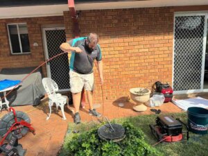 cheap Plumber inspecting a drain for pipe relining services